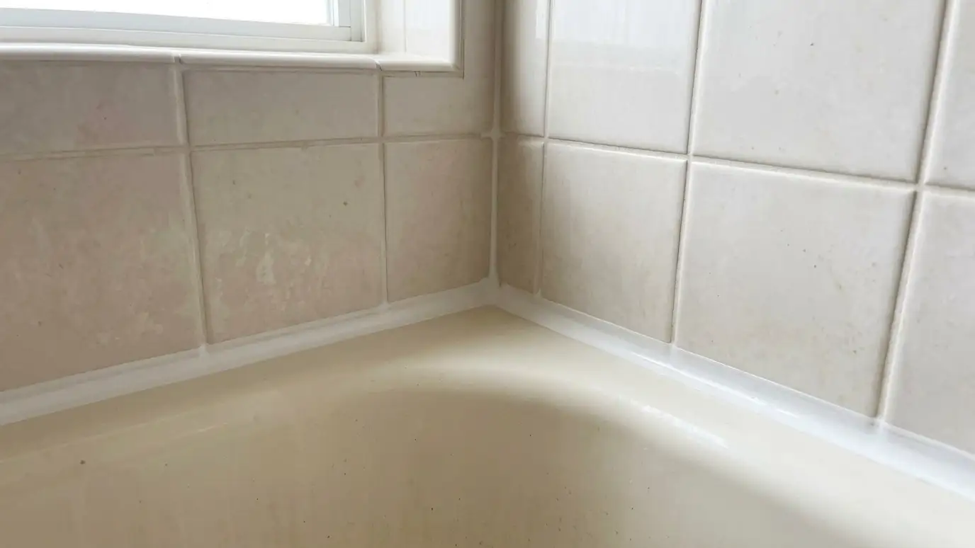 After: Moldy caulk replaced | Music City Grout After: a tub corner with a crisp fresh white caulk line and clean grout